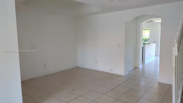 a view of an empty room with a kitchen