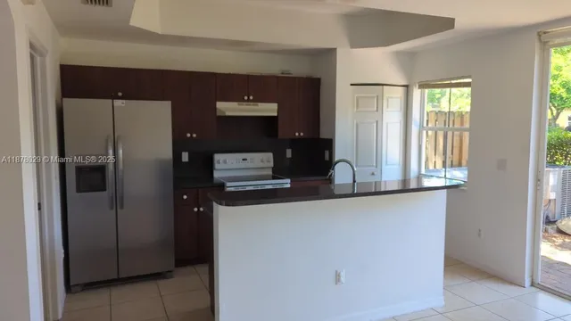 a room with pool table and windows