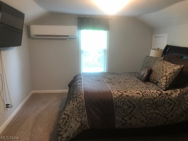 4652 South Turner Road Canfield, OH 44406 - Photo 13 of 28 Carpeted bedroom featuring a wall mounted AC and lofted ceiling