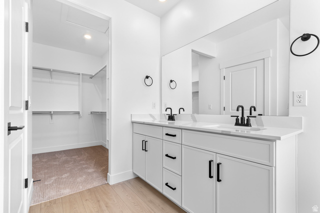 2362 1400 West, Unit 14 Perry, UT 84302 - Photo 20 of 22 Dual vanity featuring matte black faucets, white cabinetry, and a full-width mirror