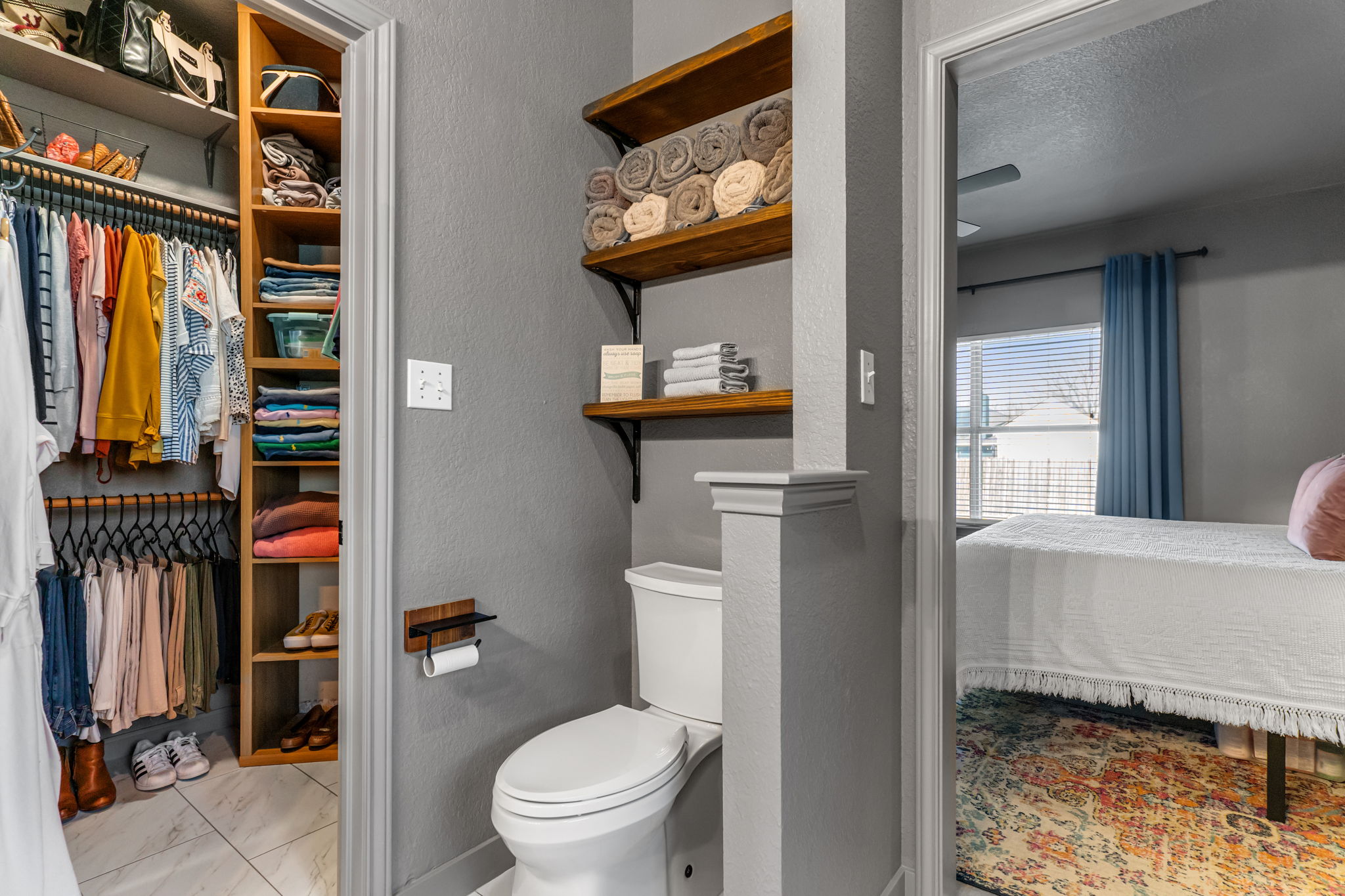 401 Kates Way Hutto, TX 78634 - Photo 19 of 37 Full bathroom with connected bathroom, a textured wall, a walk in closet, and a textured ceiling