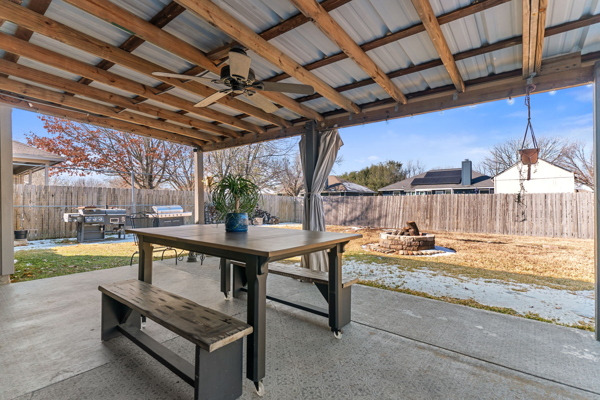 401 Kates Way Hutto, TX 78634 - Photo 32 of 37 Fenced backyard with outdoor dining space, a patio area, ceiling fan, a fire pit, and a grill