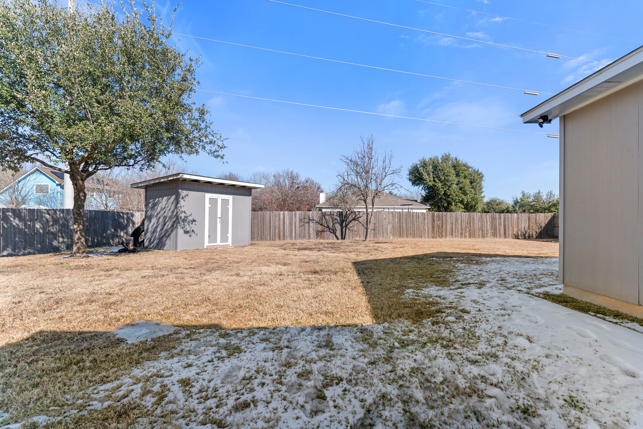 401 Kates Way Hutto, TX 78634 - Photo 34 of 37 Fenced backyard featuring a storage shed