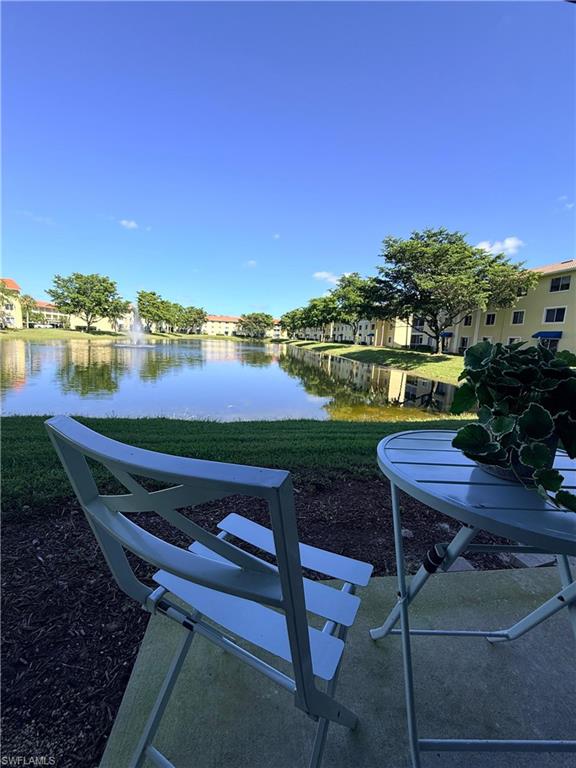 8274 Key Royal Circle, Unit 1012 Naples, FL 34119 - Photo 1 of 20 a view of a lake with outdoor seating space