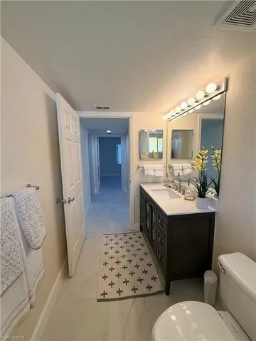 a spacious bathroom with a double vanity sink toilet and shower
