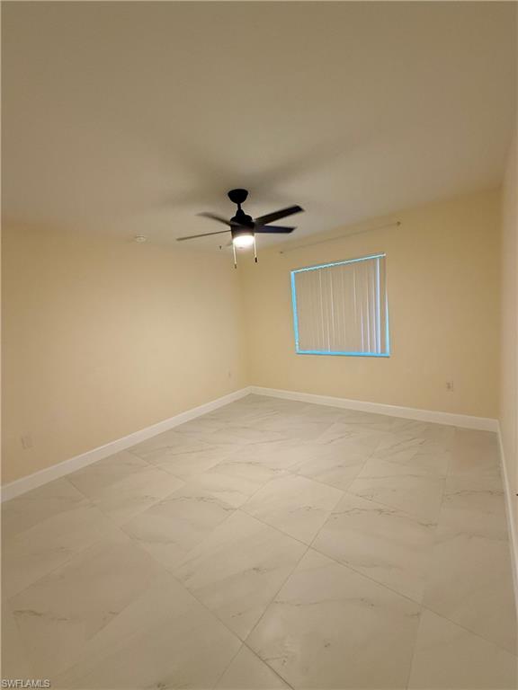 8274 Key Royal Circle, Unit 1012 Naples, FL 34119 - Photo 17 of 20 an empty room with a ceiling fan and window