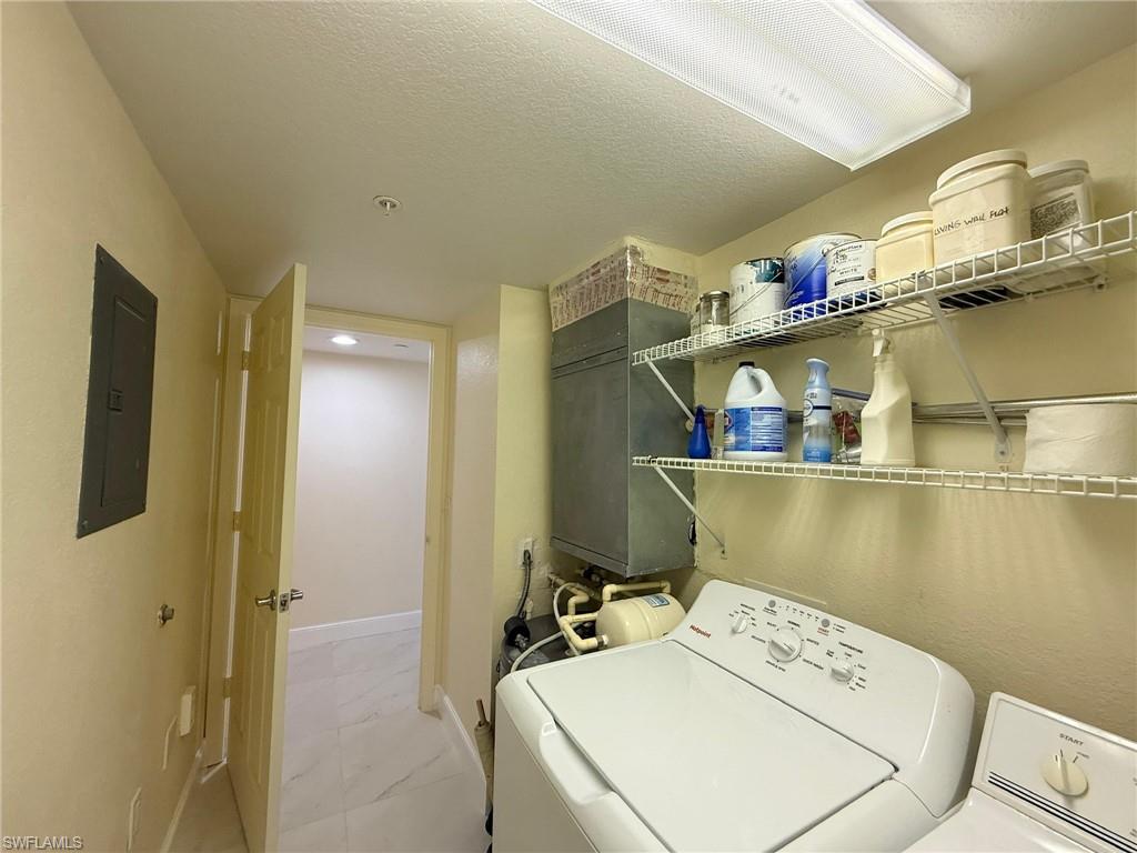 8274 Key Royal Circle, Unit 1012 Naples, FL 34119 - Photo 19 of 20 a utility room with dryer and washer