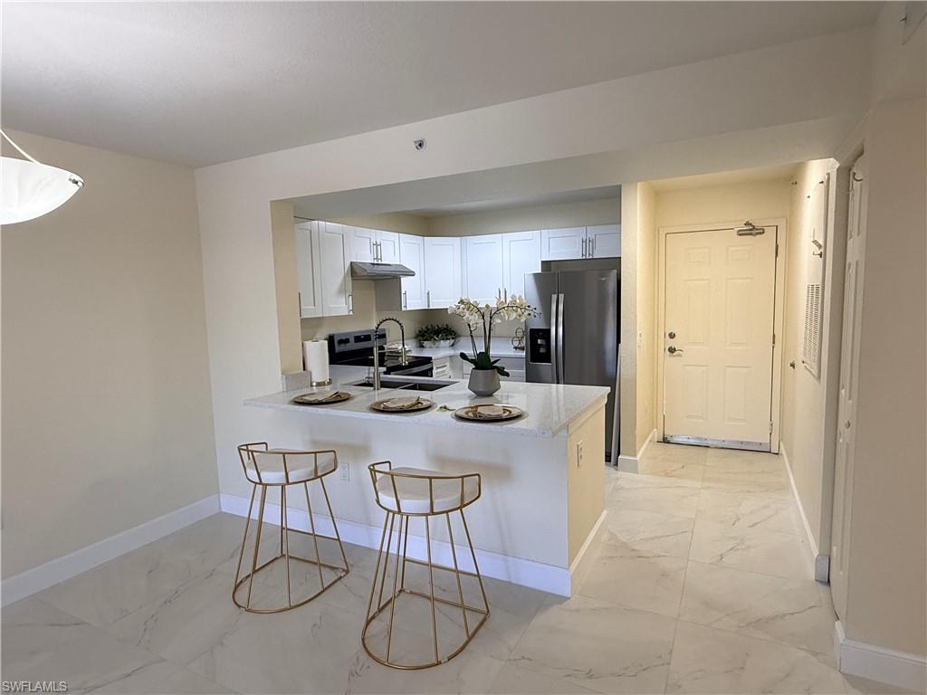 8274 Key Royal Circle, Unit 1012 Naples, FL 34119 - Photo 4 of 20 a view of a dining room with furniture