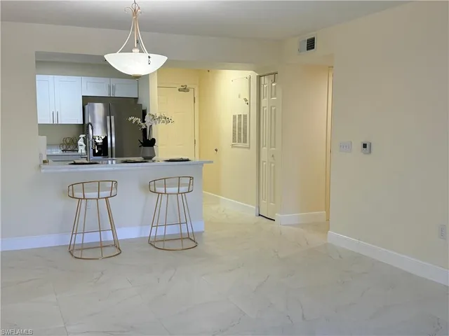 a kitchen with stainless steel appliances granite countertop a sink and a refrigerator