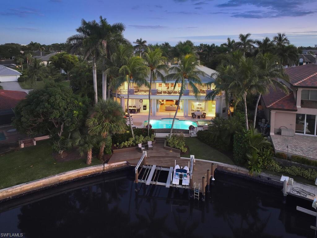 377 Pirates Bight Naples, FL 34103 - Photo 4 of 44 a view of swimming pool and lake view