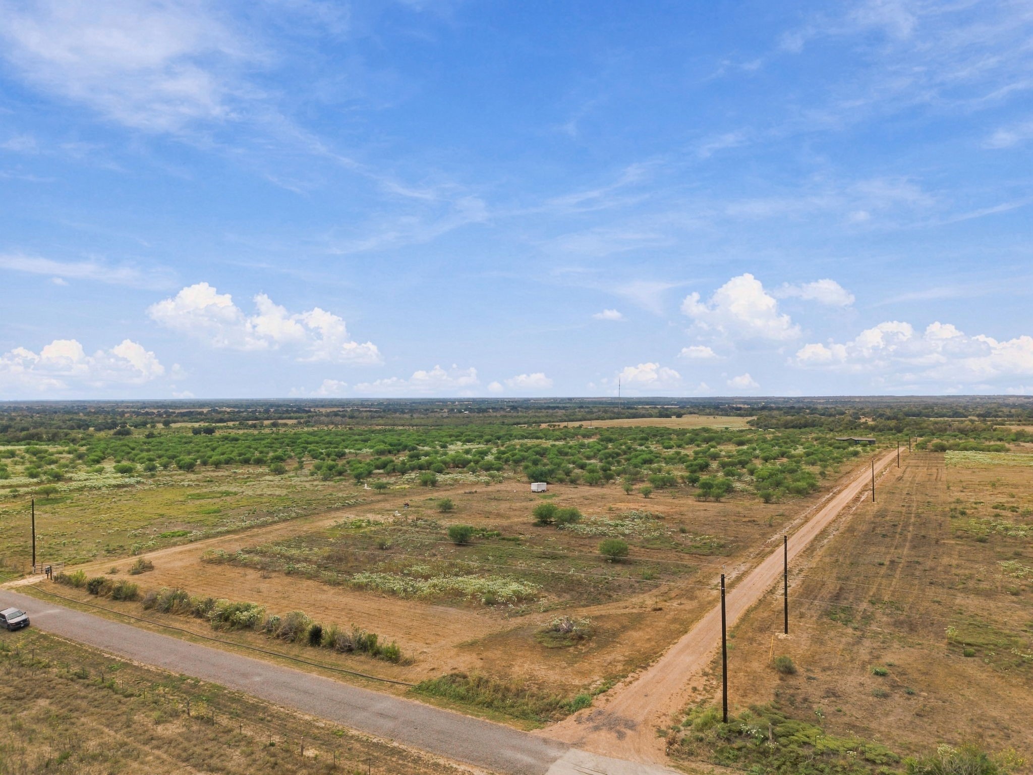 3898 Concrete-Edgar Road Cuero, TX 77954 - Photo 2 of 9 Elevated perspective showcasing expansive rural acreage with dual road frontage, gentle terrain, and scattered low vegetation.