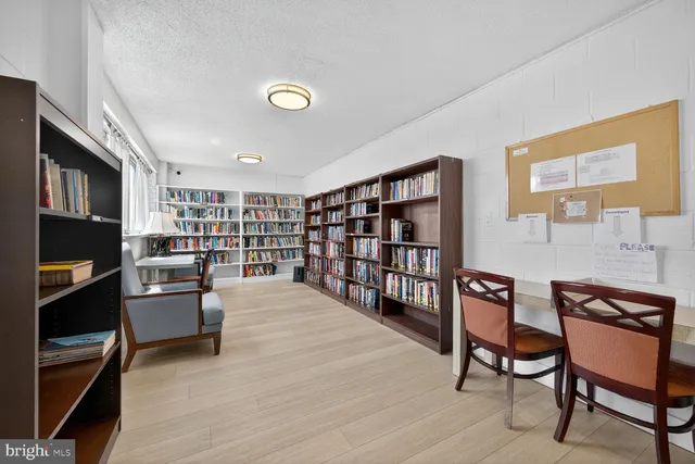 a living room with furniture and a book shelf