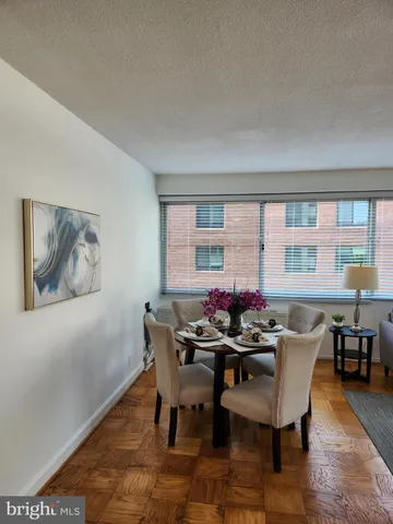 a dining room with furniture and wooden floor