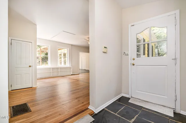 wooden floor in an empty room with a window