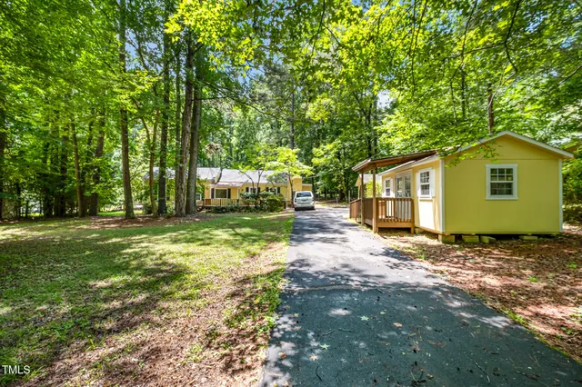 a view of a house with a backyard