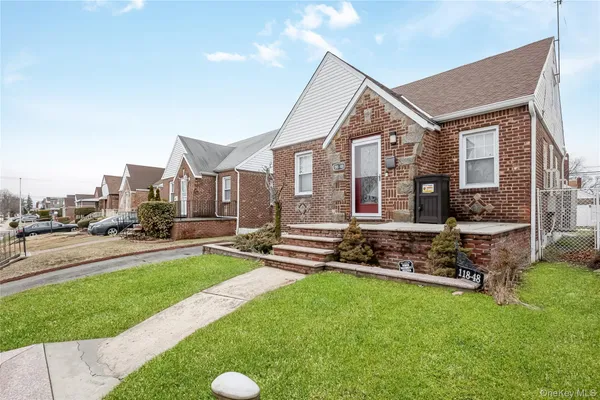a front view of a house with a yard table and chairs