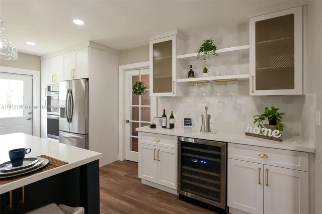 a kitchen with a sink a stove and cabinets