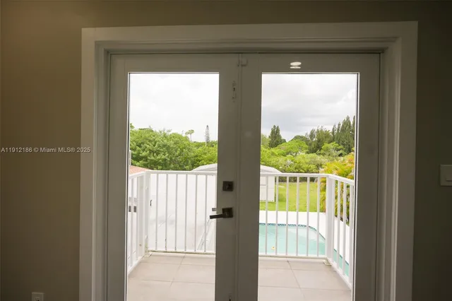 an empty room with wooden floor and a mirror