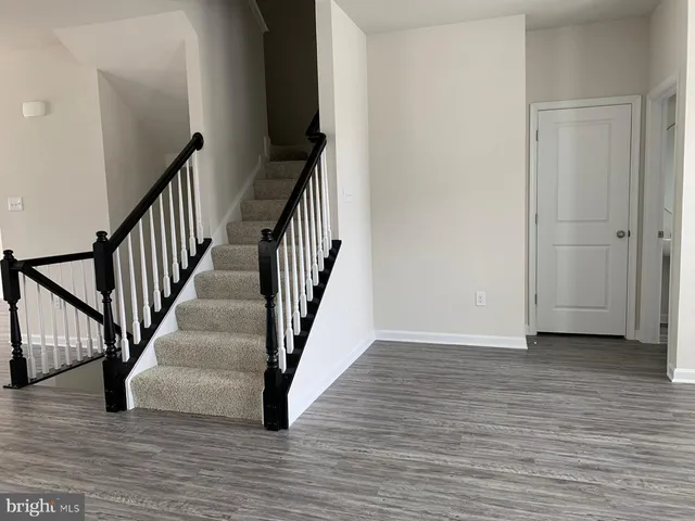 a view of an entryway with wooden floor