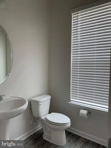 a white toilet sitting next to a window