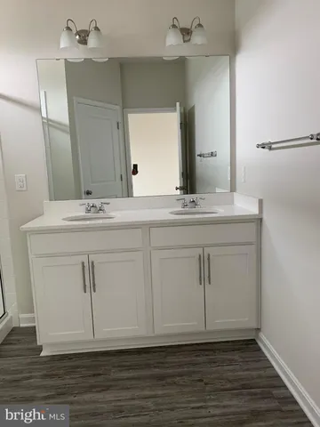 a bathroom with a sink vanity granite and a mirror