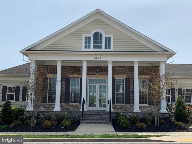 front view of brick house with a yard
