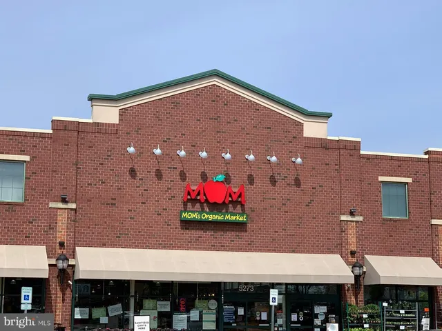 a view of a building with an outdoor space and seating area