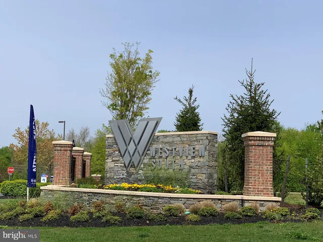 a front view of a house with a yard and fountain