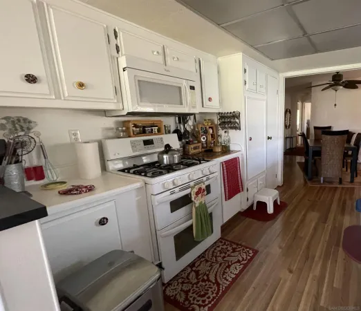 a kitchen with stainless steel appliances a stove a microwave and cabinets