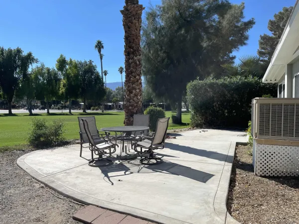 a view of a backyard with sitting area
