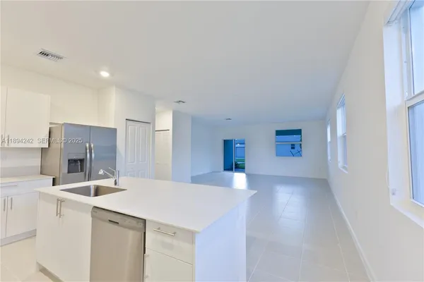 a kitchen that has a sink and a stove in it