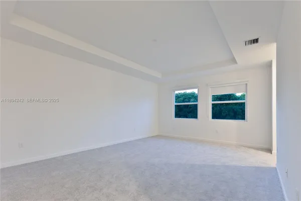 a view of an empty room with windows