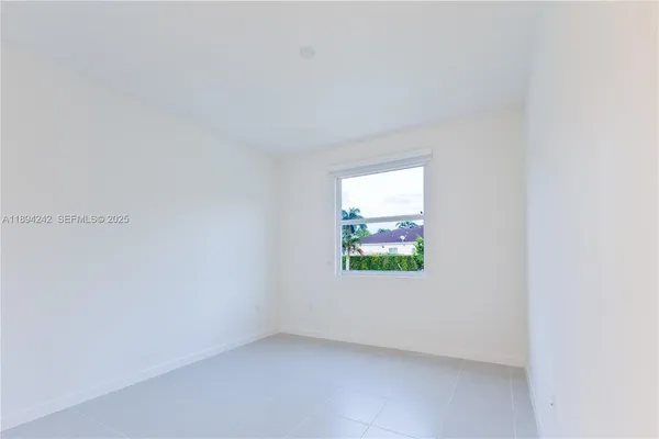 an aerial view of a house with a garden and swimming pool
