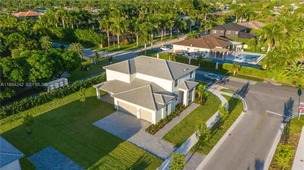 an aerial view of a house with a big yard
