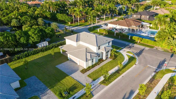 an aerial view of a house with a garden and trees