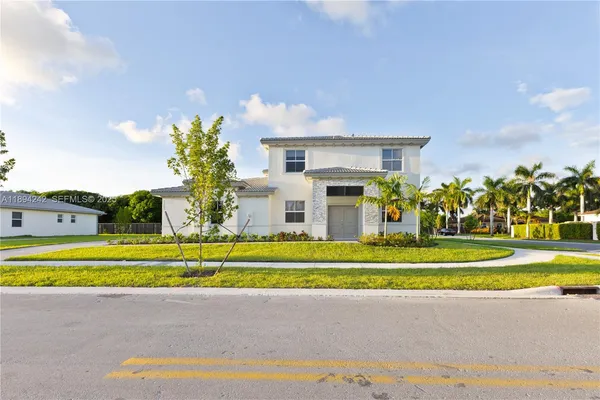 a view of a house with a swimming pool and a yard