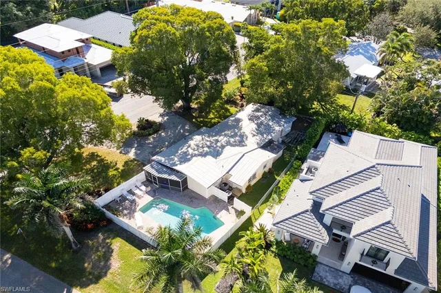 an aerial view of a house with a yard and garden