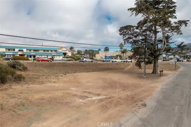 a street sign on a sidewalk next to a road