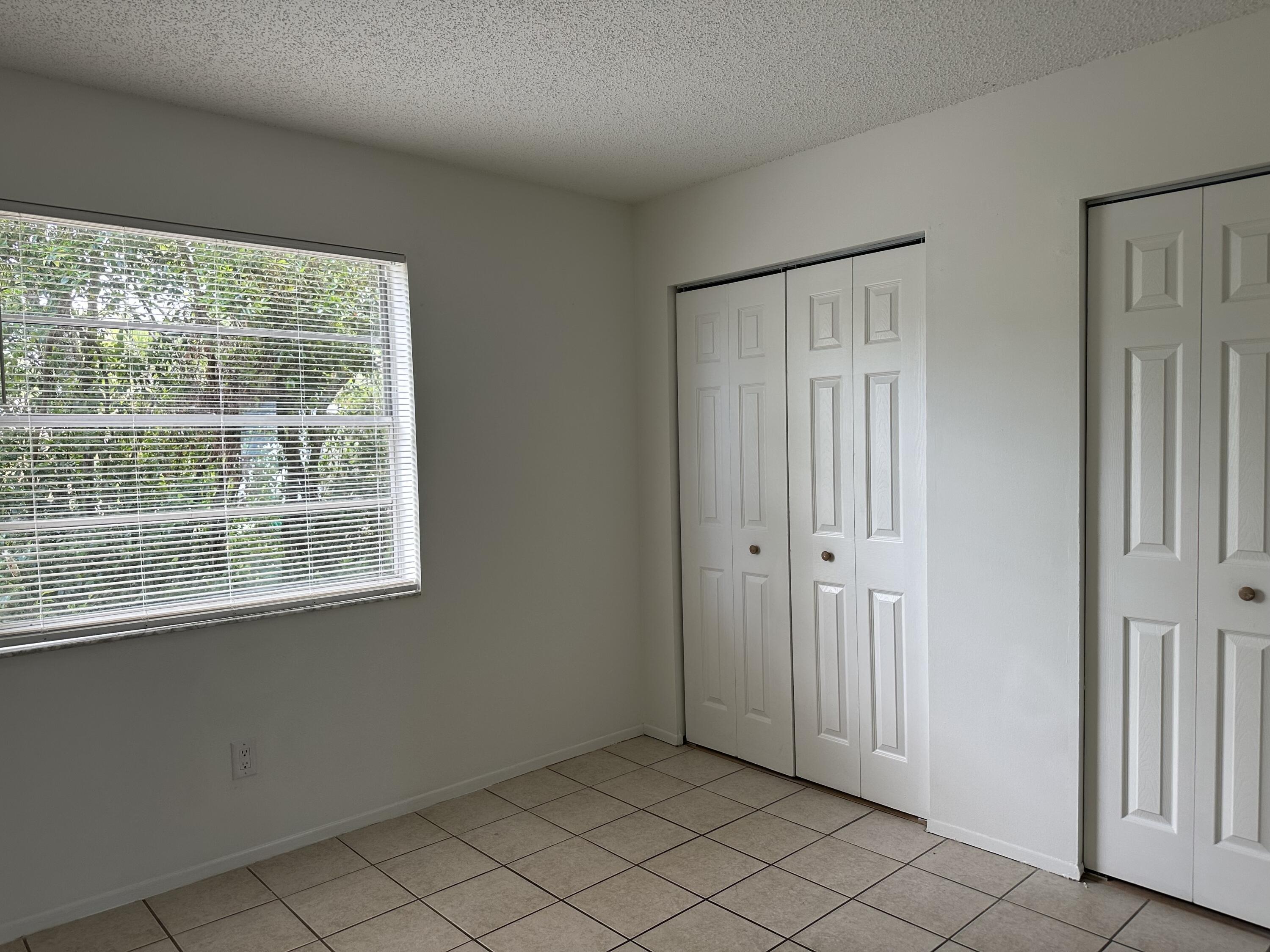 4606 Southeast Binnacle Way, Unit 1 Stuart, FL 34997 - Photo 4 of 5 an empty room with windows