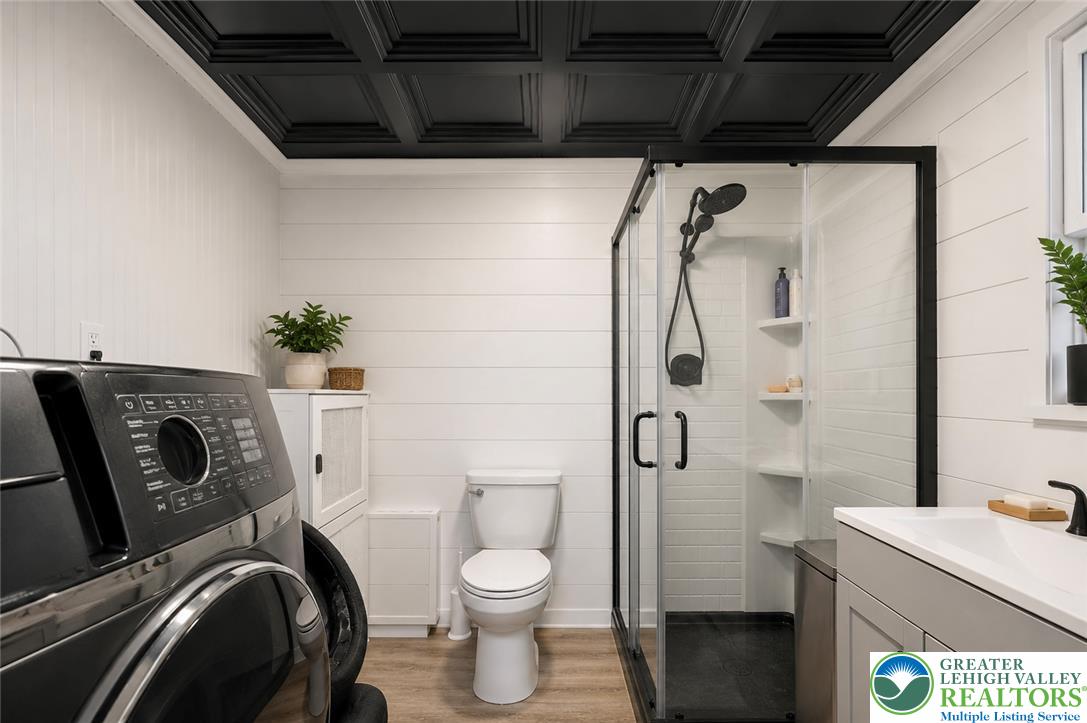 9033 Loop Road Slatington, PA 18080 - Photo 5 of 53 A chic laundry and bath combo featuring a sleek shower and elegant coffered ceiling.