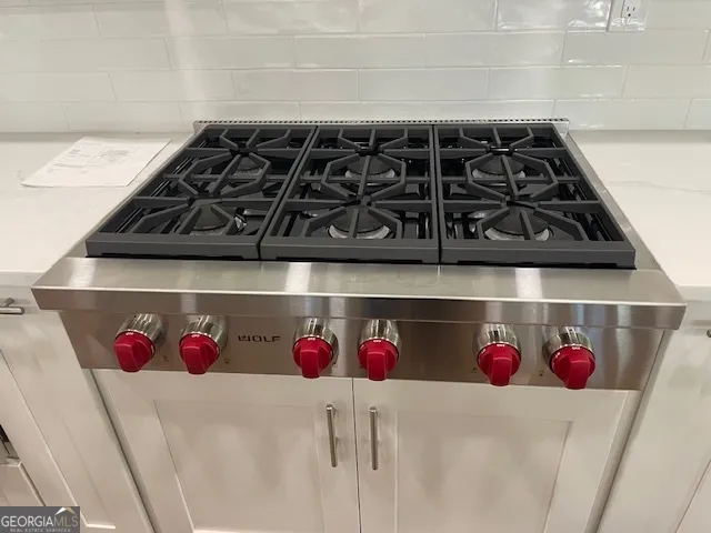 a living room with furniture fireplace and a large window