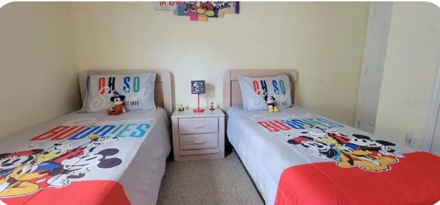 a bedroom with a bed and flat screen tv