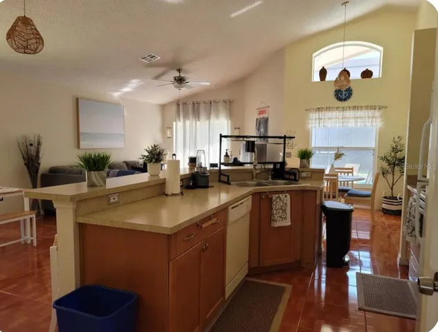 a kitchen with stainless steel appliances granite countertop a sink counter space cabinets and a counter top space