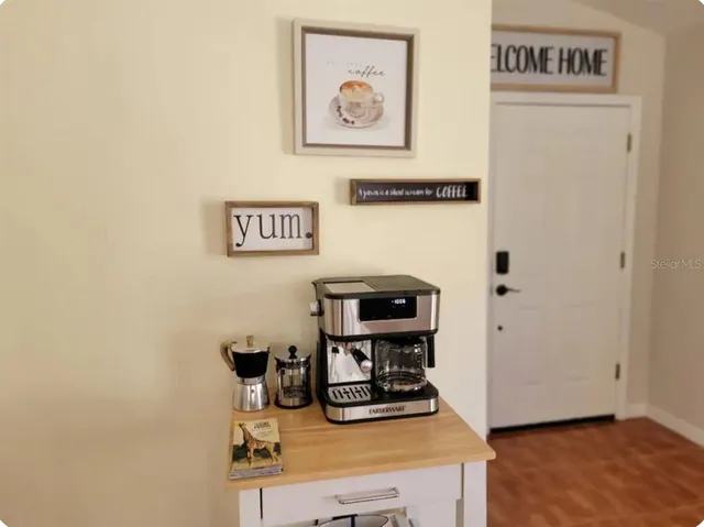 a view of a workspace with furniture and wooden floor