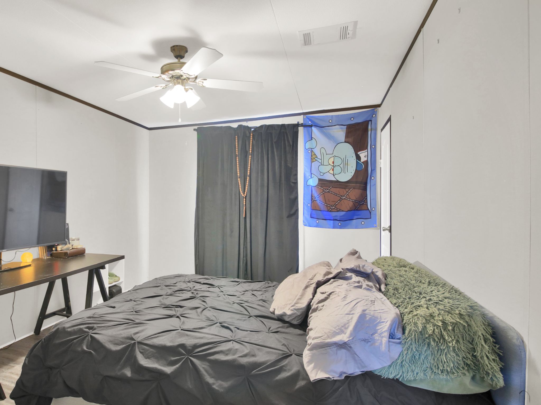271 Alma Lane Kyle, TX 78640 - Photo 15 of 25 a bedroom with a bed and a chandelier
