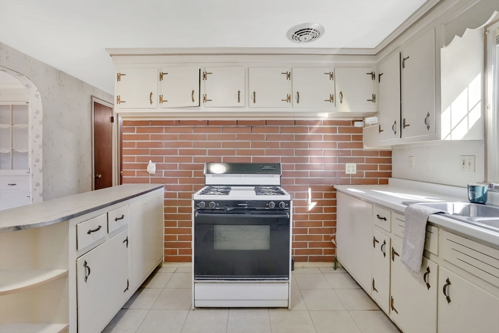 865 South Branch Parkway Springfield, MA 01118 - Photo 12 of 35 a kitchen with cabinets stainless steel appliances and a stove