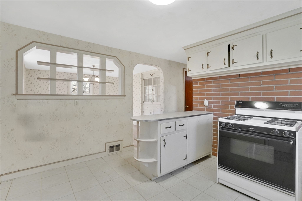 865 South Branch Parkway Springfield, MA 01118 - Photo 7 of 35 a kitchen with granite countertop white cabinets stainless steel appliances and sink