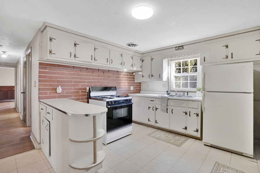 865 South Branch Parkway Springfield, MA 01118 - Photo 8 of 35 a kitchen with granite countertop a sink stove and refrigerator