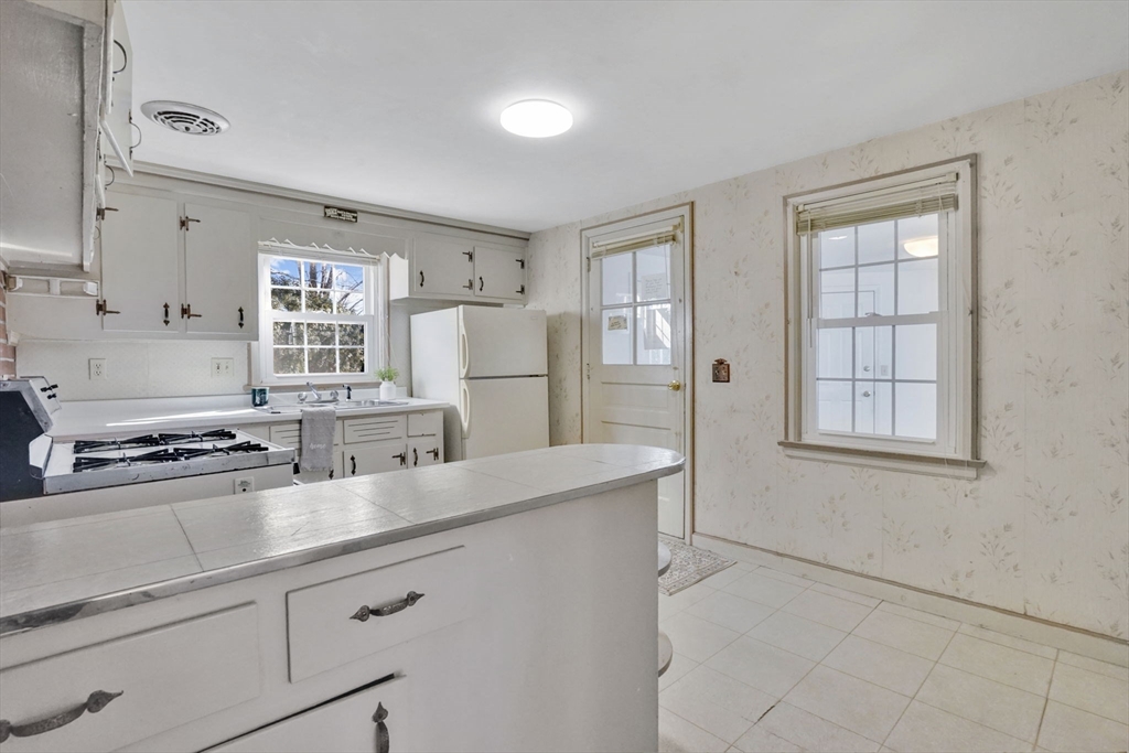 865 South Branch Parkway Springfield, MA 01118 - Photo 9 of 35 a kitchen with a sink stove and refrigerator