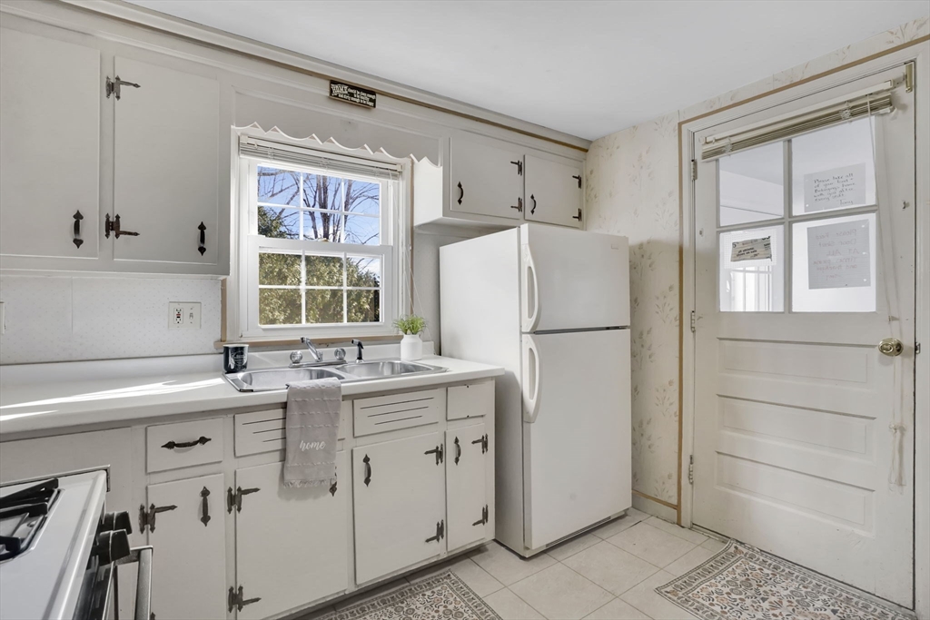 865 South Branch Parkway Springfield, MA 01118 - Photo 10 of 35 a kitchen with a refrigerator sink stove and cabinets